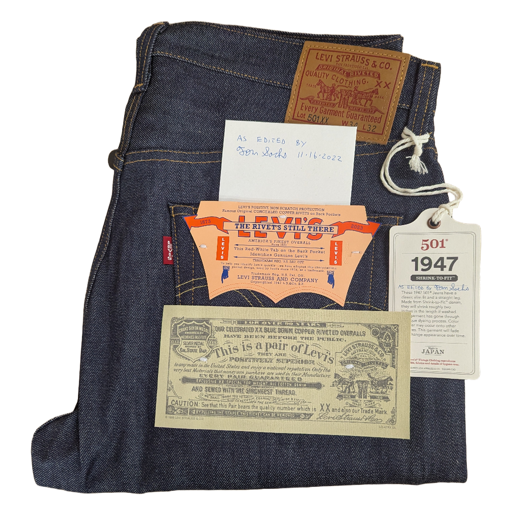 Levi's jeans with vintage advertisements and tags on a white background