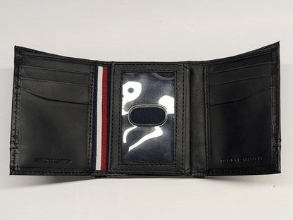 Black wallet with a brand logo on a light gray background