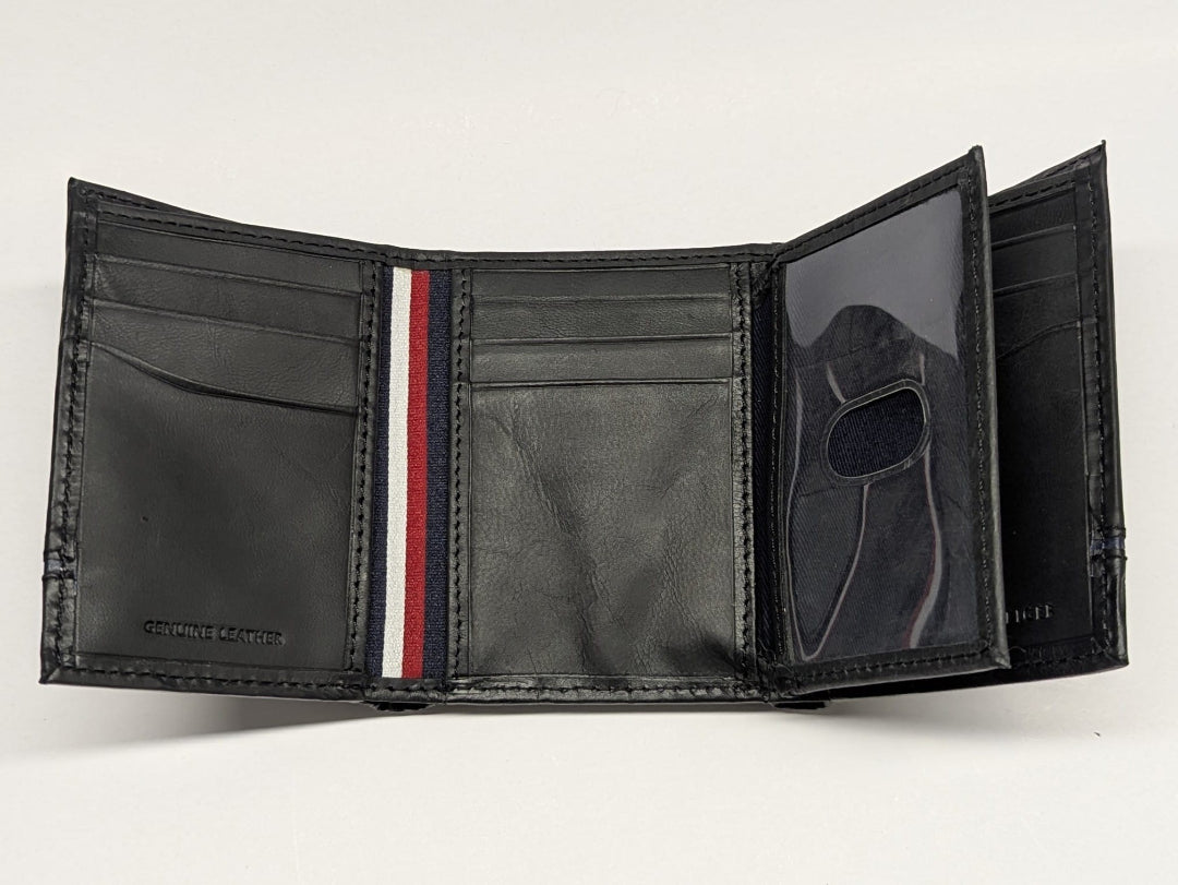 Black leather wallet with a red and white striped detail on a light gray background
