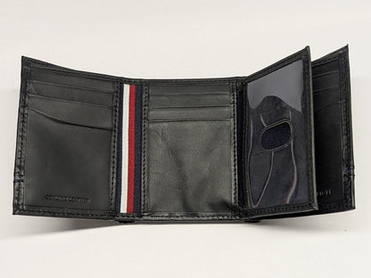 Black leather wallet with a red and white striped detail on a light gray background