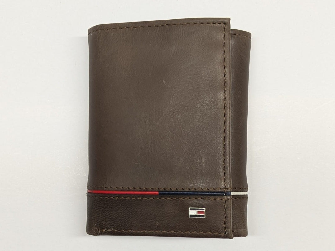 Brown leather wallet with a red and blue stripe on a light gray background