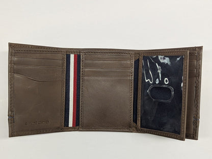 Brown leather wallet with striped detail on a white background
