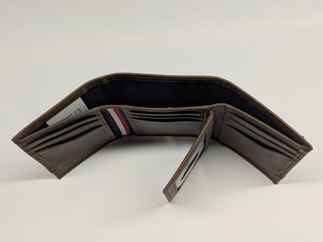 Brown leather wallet with a striped interior on a white background