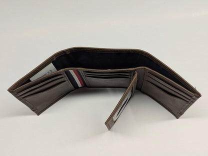 Brown leather wallet with a striped interior on a white background