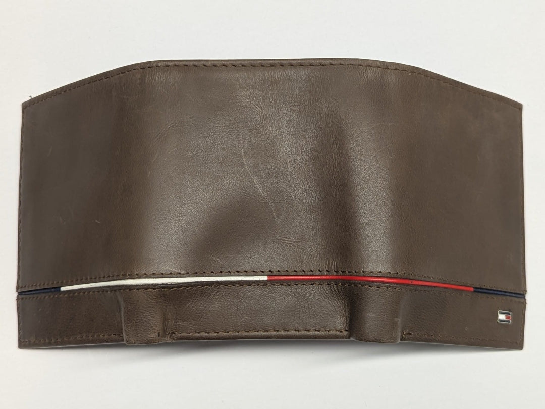 Brown leather wallet with visible brand logo on a light gray background