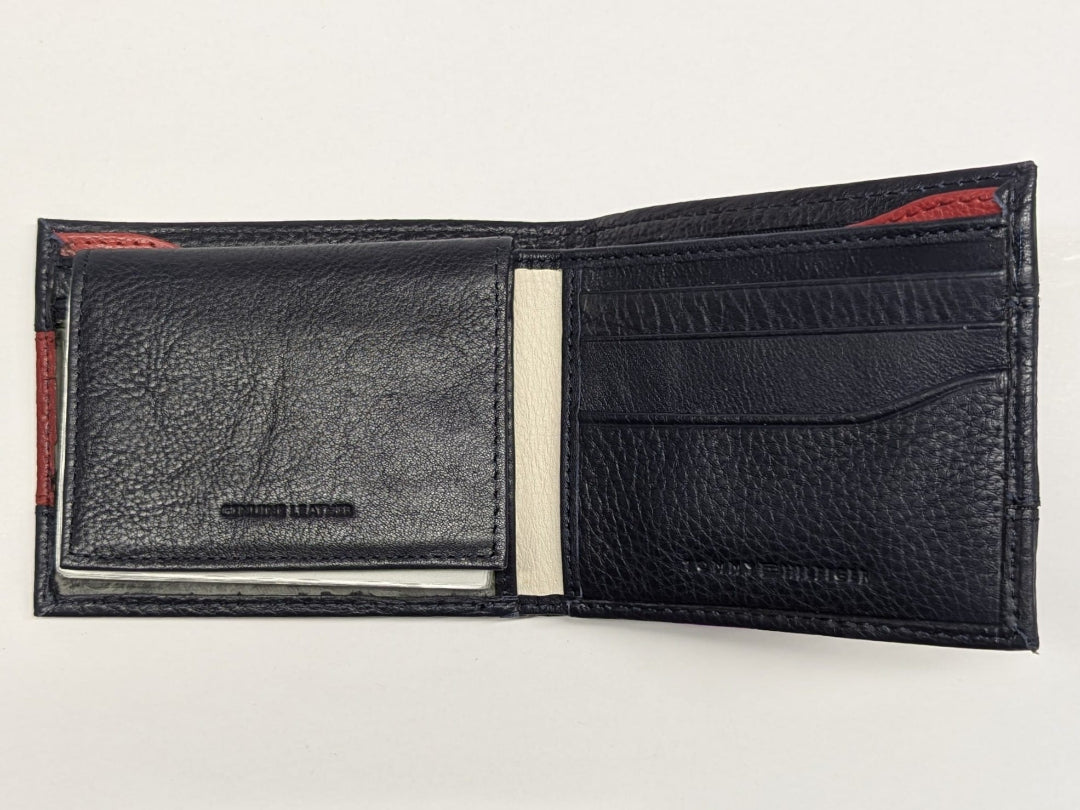 Black leather wallet with red accents on a light gray background
