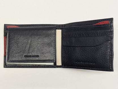 Black leather wallet with red accents on a light gray background