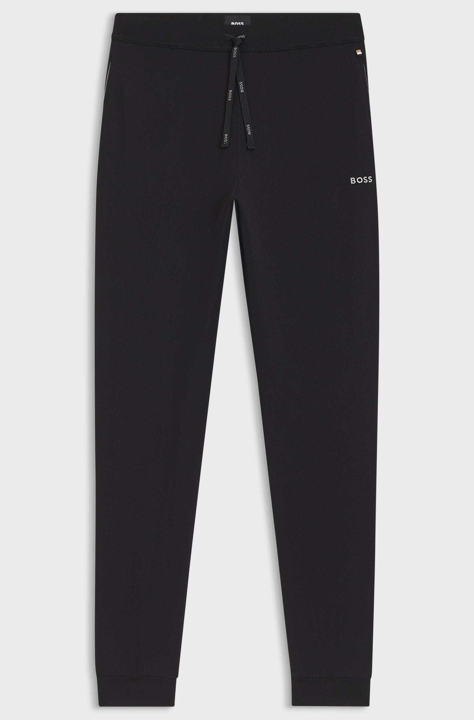Black pants with a brand logo on a light gray background