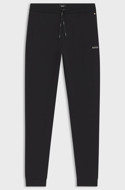 Black pants with a brand logo on a light gray background