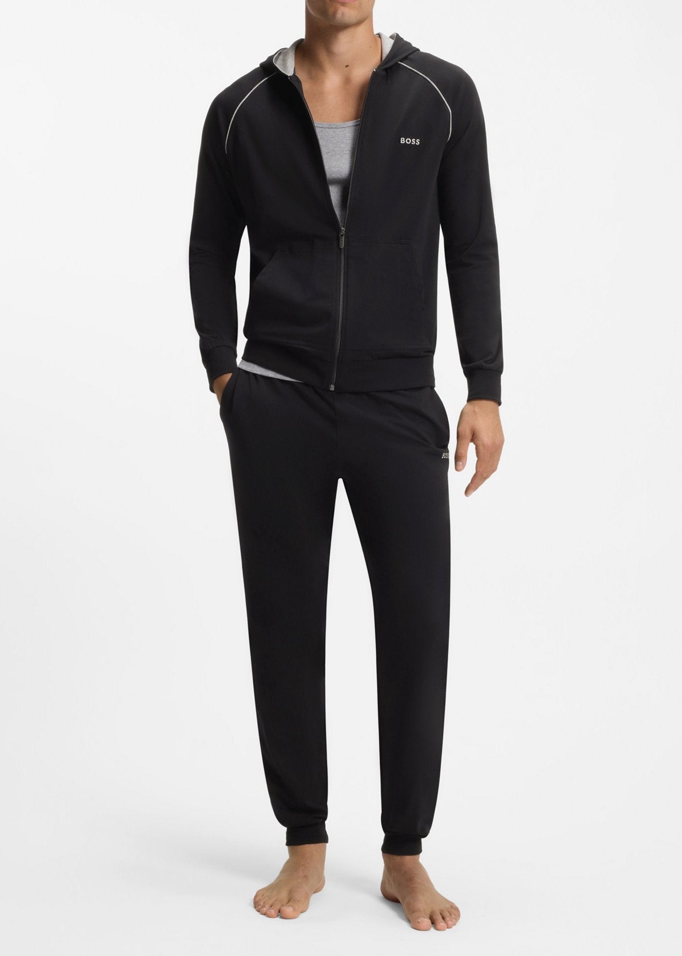 Man wearing a black tracksuit on a white background