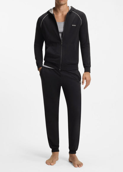 Man wearing a black tracksuit on a white background