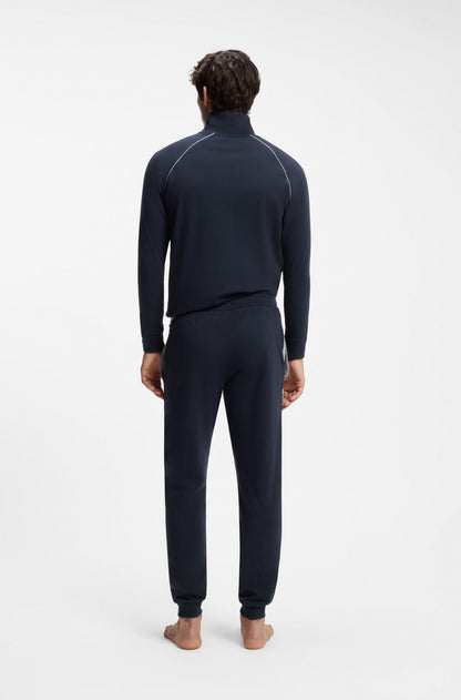 Person wearing a navy blue tracksuit on a white background