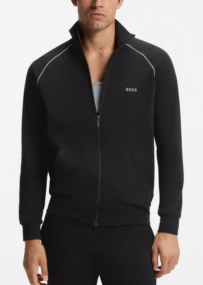 Man wearing a black tracksuit with a brand logo on a white background