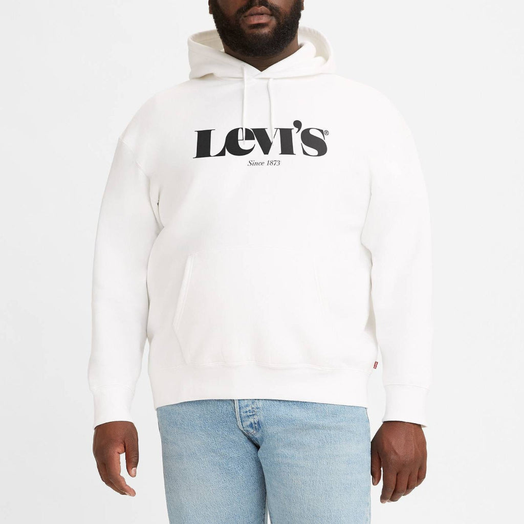 Man wearing a Levi's hoodie and light blue jeans on a white background