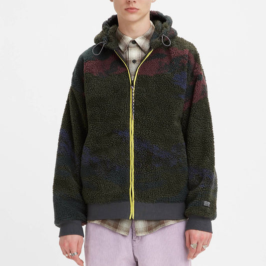 Person wearing a patterned jacket with a hood on a white background
