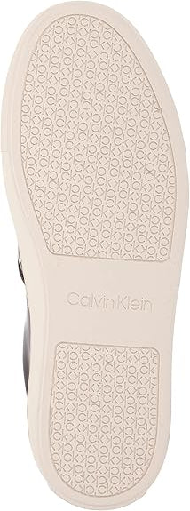 Close-up of a shoe sole with 'Calvin Klein' branding on a white background