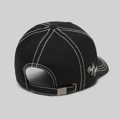 Black cap with white stitching on a gray background