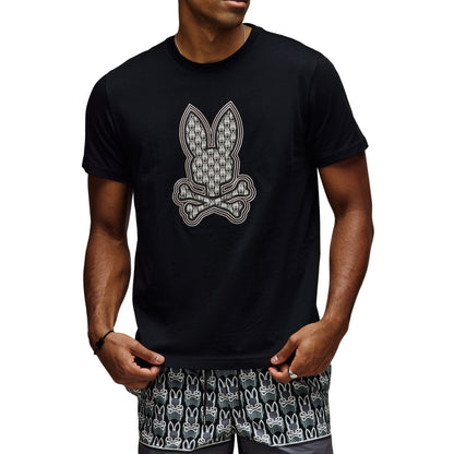Man wearing a black t-shirt with a graphic design and matching shorts on a white background