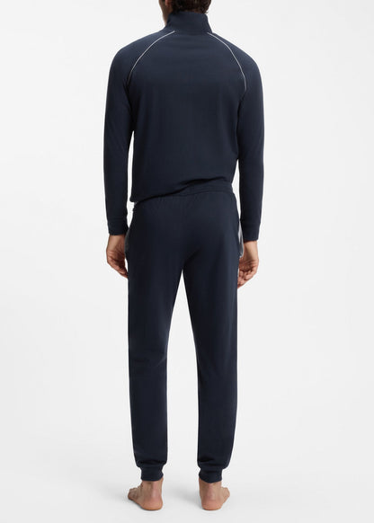 Person wearing a navy blue tracksuit on a white background