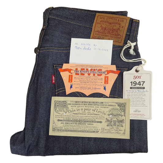 Levi's jeans with vintage advertisements and tags on a white background